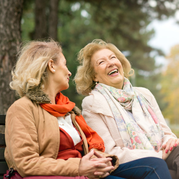 two senior women laughing